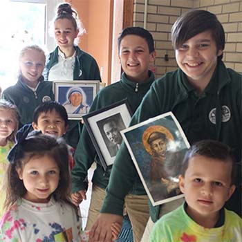 Students holding pictures of Jesus