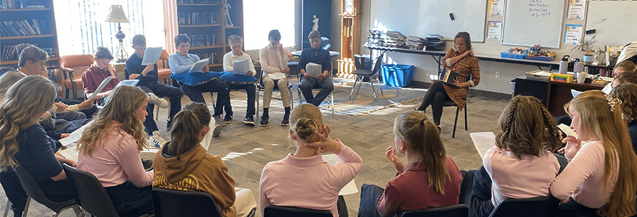 Students sitting in a partial circle with their teacher