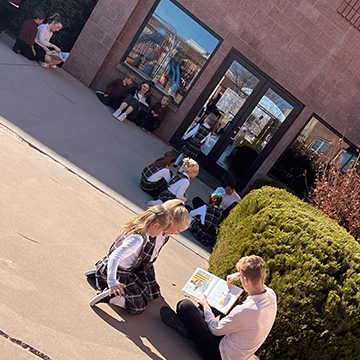 students reading books in small groups