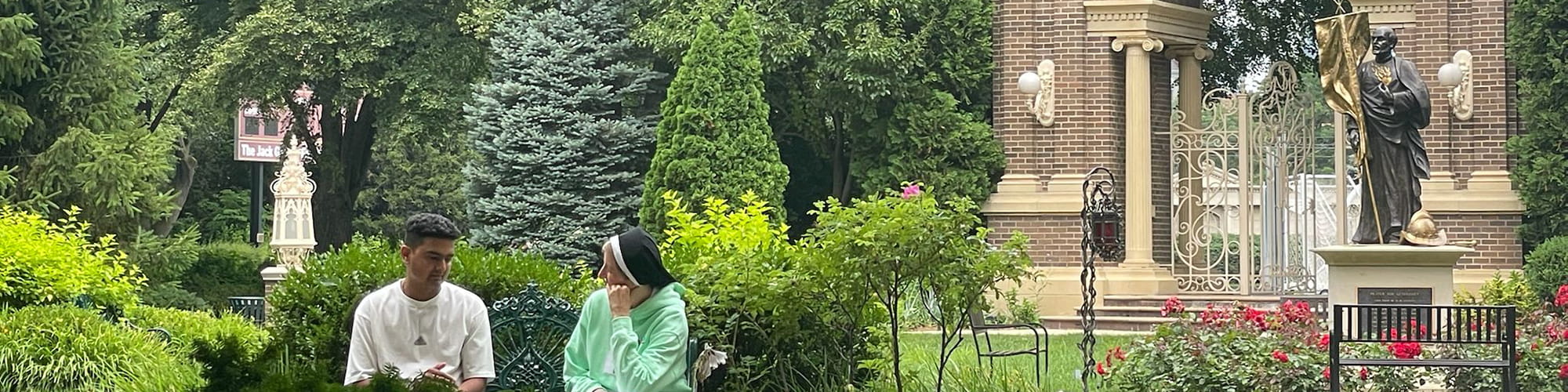 Sister sitting with patronage on a bench outside