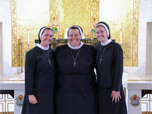Three happy sisters posing for a photo