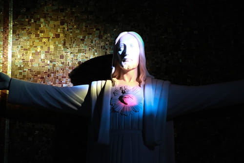 Image of a statue of Jesus with sunlight shining on it