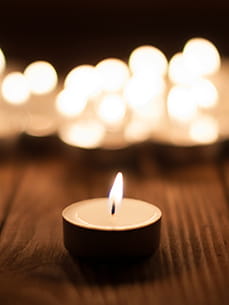 single candle lit in memory