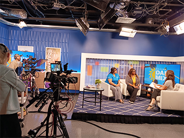 Staff member talking on a studio set