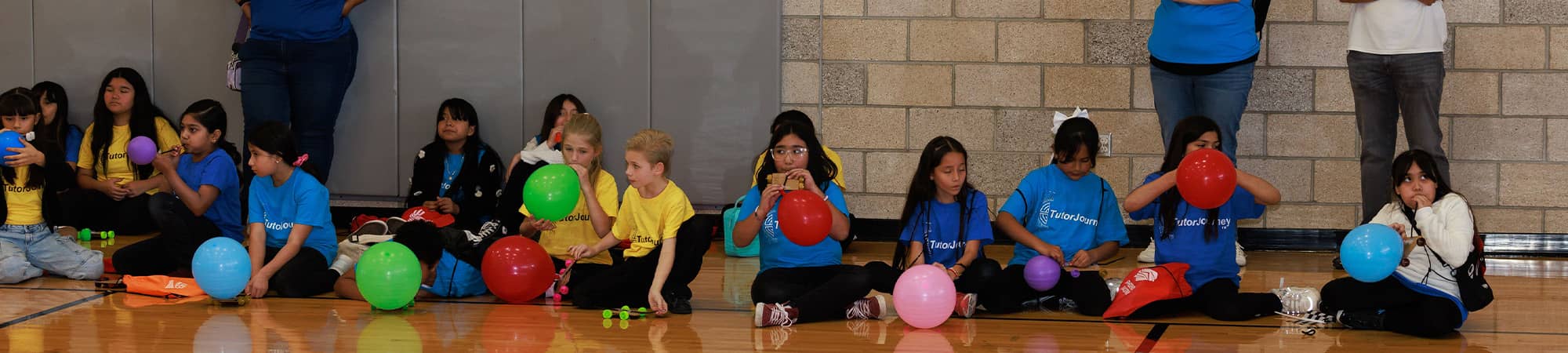 Students sitting with balloons