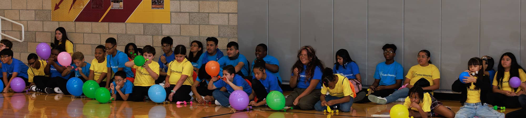 Students sitting with balloons