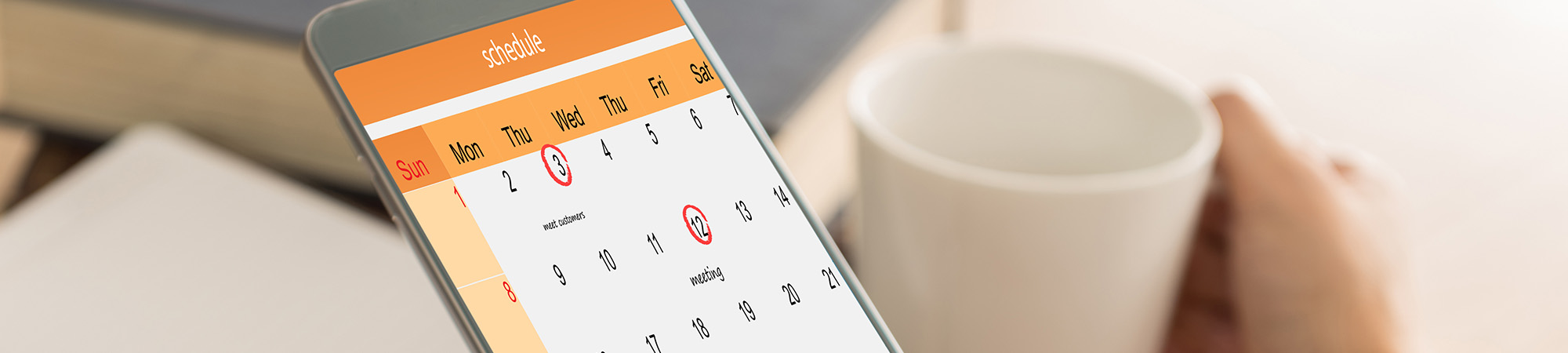 Parent holding up mobile phone displaying her schedule