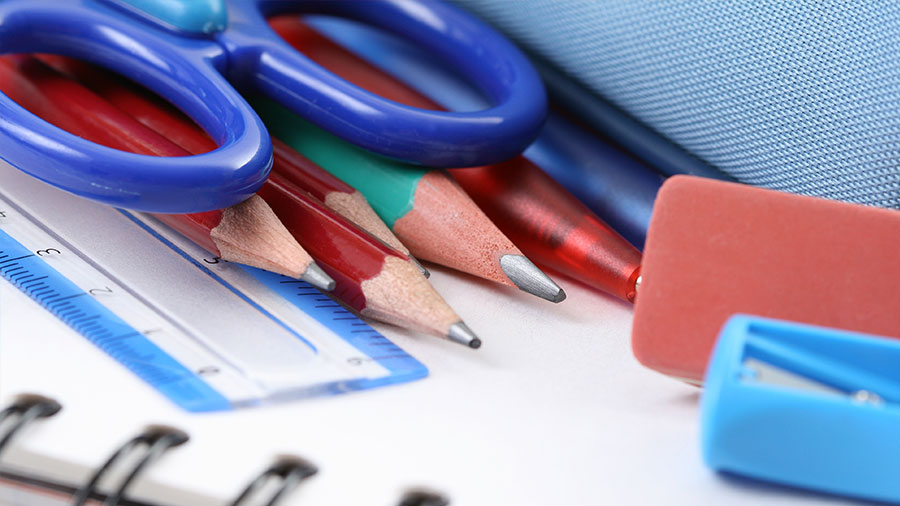School supplies on top of a notebook