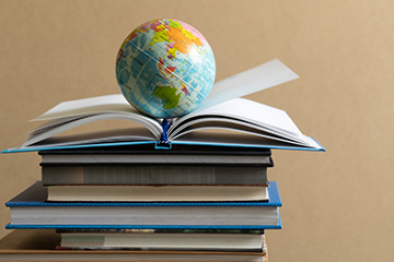 Books And Textbook On Wooden Desk