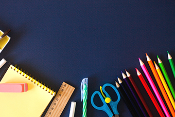 School supplies arranged on a blue background