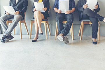 Adults in an office waiting to be interviewed