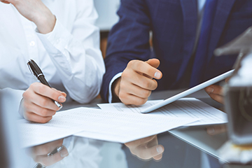 Two staff members working together at a table