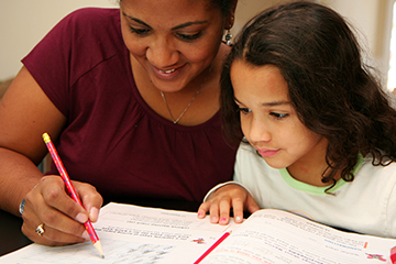 A mother helping her daughter with homework