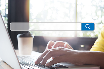 an orchard with a barn in the background