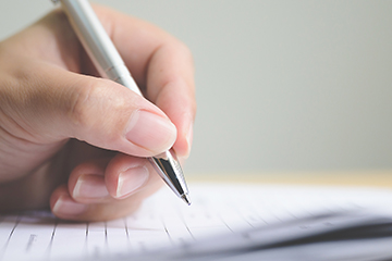 Student writing in a notebook