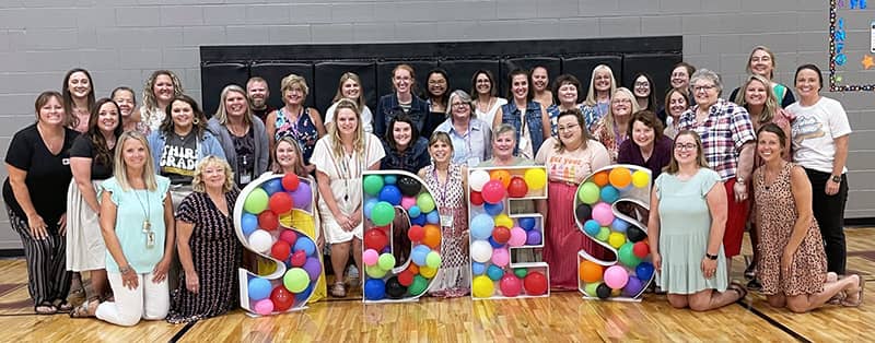 Group photo of happy teachers and staff