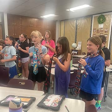Students learning to tie a necktie