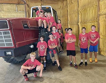 Students group photo with a tractor