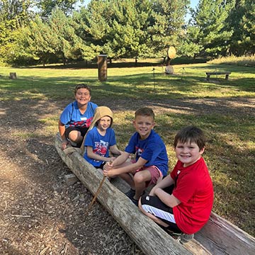 Students sitting in a canoe outside