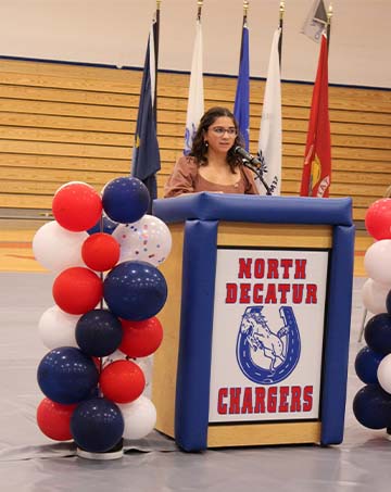 student giving a speech at a podium