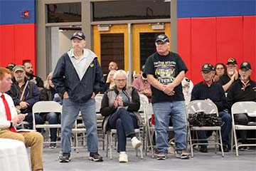 Two veterans standing at an event