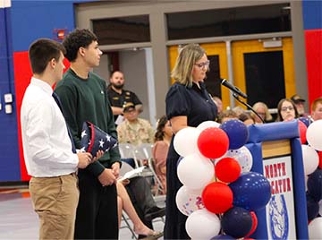 teacher giving a speech at a veterans event