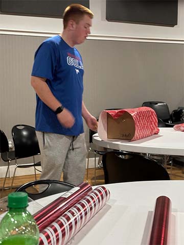 Student wrapping presents