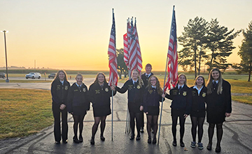 Students outside honoring veterans with USA flags