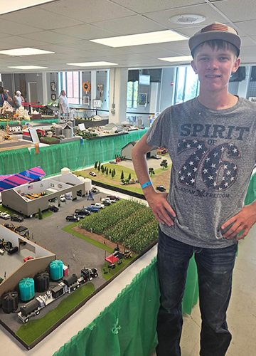 Student next to agriculture models