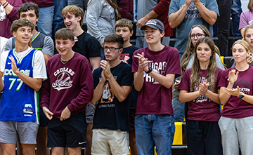 Students cheering during a basketball game