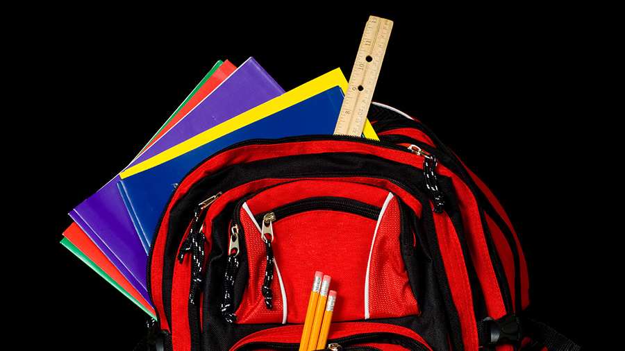 Red backpack filled with school supplies