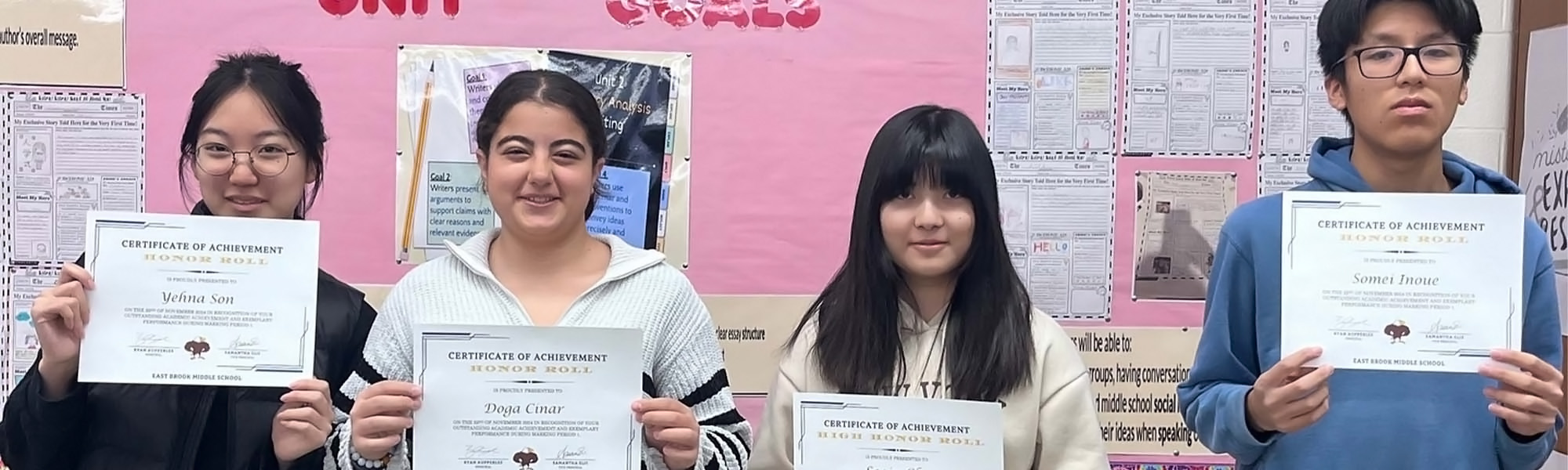 Students holding honor roll awards