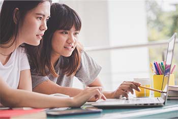 two students working on a computer