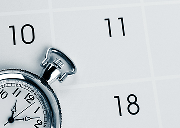 Notebook on desk in the classroom Stopwatch on top of a calendar