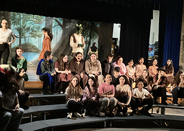 Drama club members posting for picture near the stage