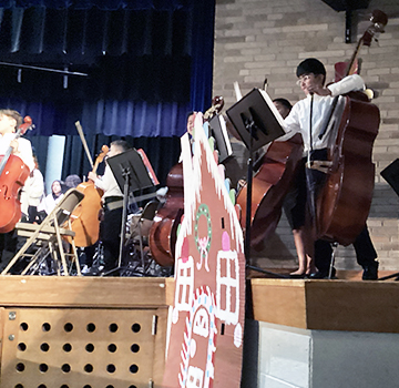 Musical students performing on a stage
