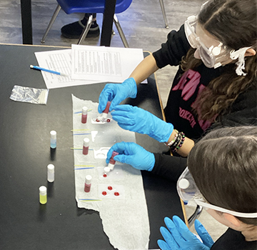 Notebook on desk in the classroom Students in the science lab