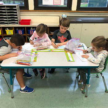 Notebook on desk in the classroom Students doing their schoolwork