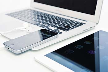 Notebook on desk in the classroom smart devices together