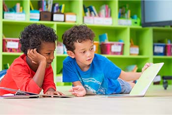 Notebook on desk in the classroom Two students working together