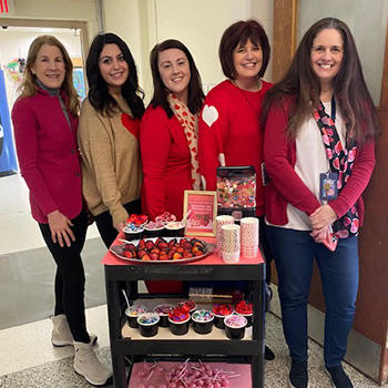Adults delivering food on a rolling tray