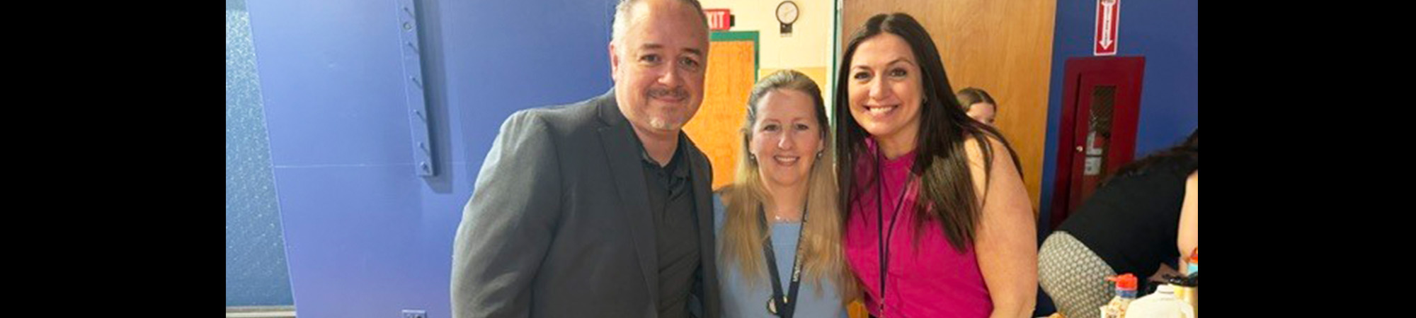 Principal with two female staff members posing for a picture