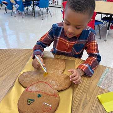 School girl smiling and writing at her desk