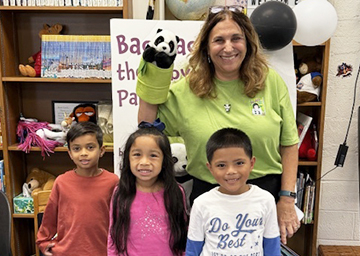 Teacher with puppet and three students