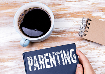 Cup of coffee next to parenting booklet