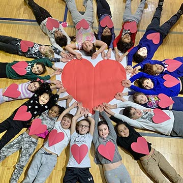 Students making a big heart shape together