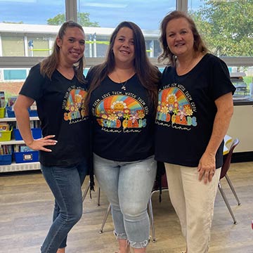 Three staff members smiling