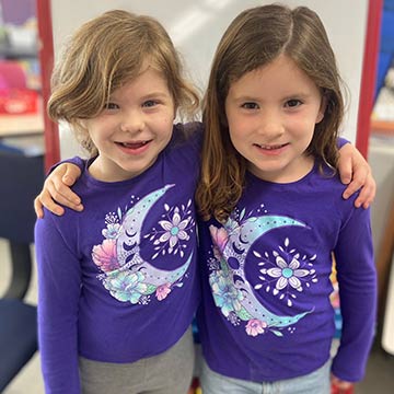 Two girls in matching shirts