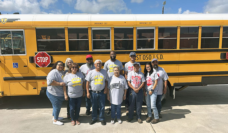Transportation team in front of a school bus