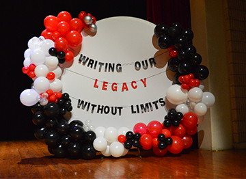 Writing our legacy without limits banner with red and black balloons